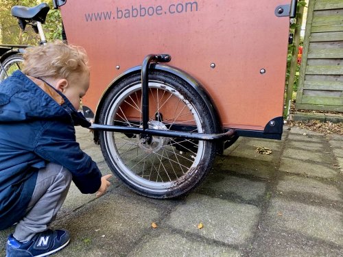 My small colleague inspecting the damage to the cargo bike